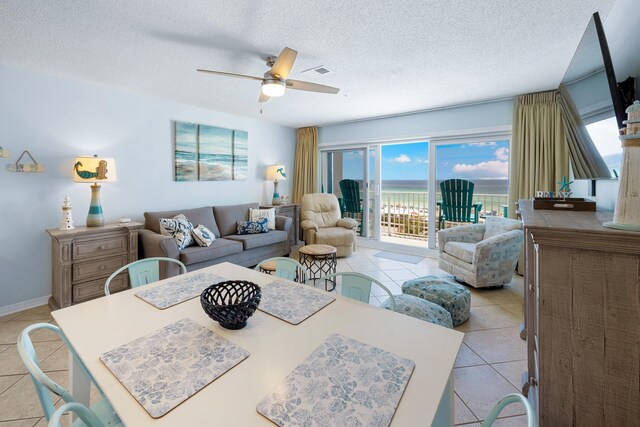 2606 Scenic Gulf Dr Unit 2412, Miramar Beach, FL 32550 - dining area with light tile patterned floors, plenty of natural light, a ceiling fan, and a textured ceiling