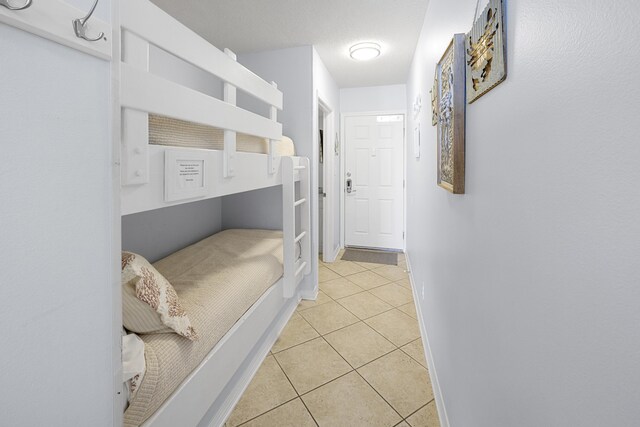 2606 Scenic Gulf Dr Unit 2412, Miramar Beach, FL 32550 - bedroom featuring light tile patterned flooring and baseboards