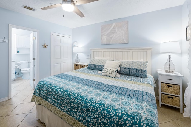 2606 Scenic Gulf Dr Unit 2412, Miramar Beach, FL 32550 - bedroom featuring light tile patterned floors, ensuite bathroom, a ceiling fan, a closet, and baseboards