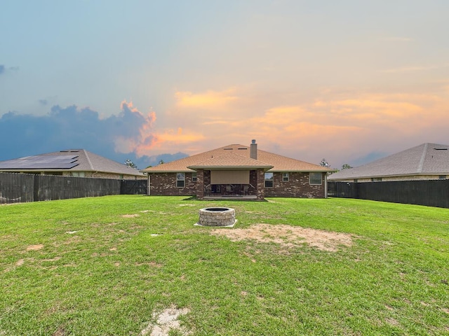 5740 Marigold Loop, Crestview, FL 32539 - back of house featuring an outdoor fire pit, a chimney, and brick siding