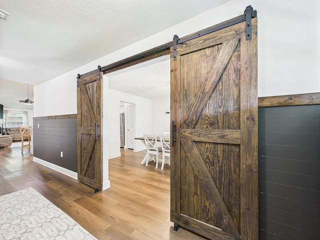 5740 Marigold Loop, Crestview, FL 32539 - corridor featuring a barn door and wood finished floors
