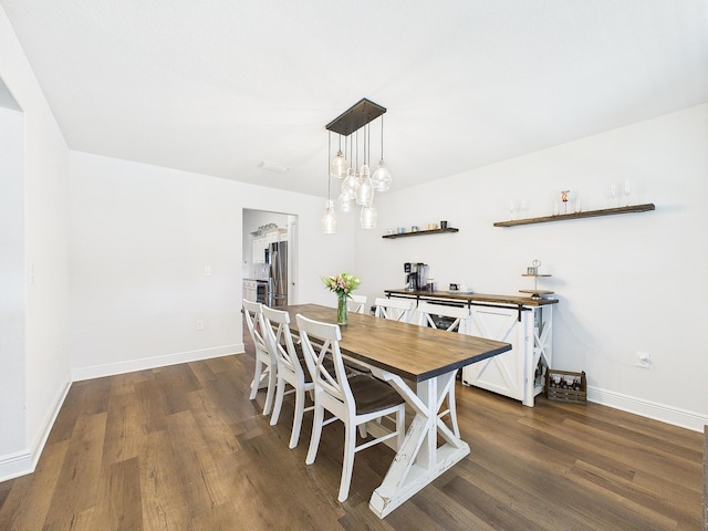 5740 Marigold Loop, Crestview, FL 32539 - dining area featuring dark wood-type flooring and baseboards