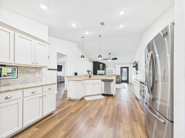 5740 Marigold Loop, Crestview, FL 32539 - kitchen featuring appliances with stainless steel finishes, vaulted ceiling, light wood-style flooring, a sink, and a ceiling fan