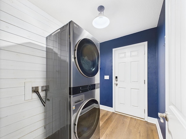 5740 Marigold Loop, Crestview, FL 32539 - laundry room featuring stacked washer / dryer, baseboards, and wood finished floors