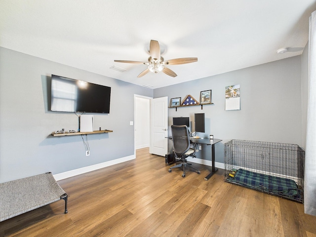 5740 Marigold Loop, Crestview, FL 32539 - home office featuring wood finished floors, a ceiling fan, and baseboards