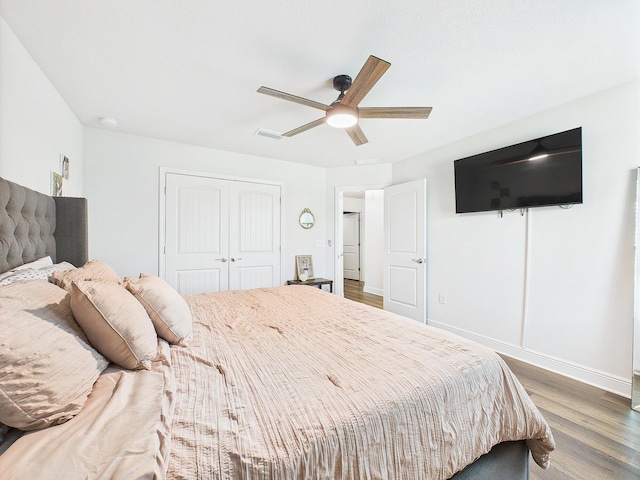 5740 Marigold Loop, Crestview, FL 32539 - bedroom featuring wood finished floors, a closet, baseboards, and ceiling fan