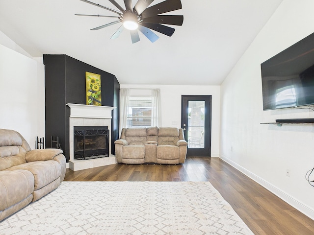 5740 Marigold Loop, Crestview, FL 32539 - living room featuring vaulted ceiling, ceiling fan, dark wood-style flooring, a fireplace with raised hearth, and baseboards