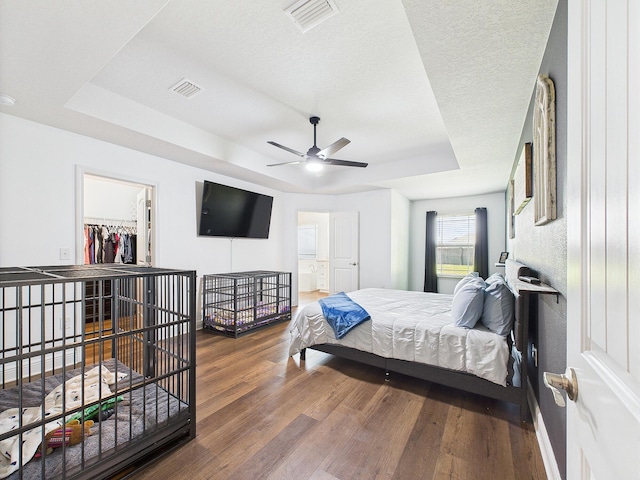 5740 Marigold Loop, Crestview, FL 32539 - bedroom with a raised ceiling, wood finished floors, baseboards, a walk in closet, and a ceiling fan