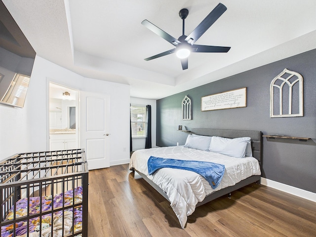 5740 Marigold Loop, Crestview, FL 32539 - bedroom with wood finished floors, a raised ceiling, baseboards, and ceiling fan