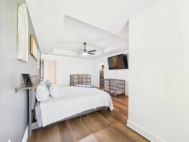 5740 Marigold Loop, Crestview, FL 32539 - bedroom with baseboards, wood finished floors, a raised ceiling, and ceiling fan