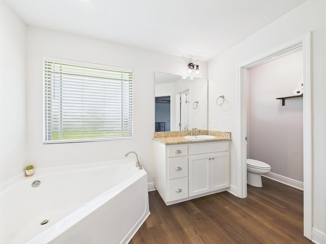 5740 Marigold Loop, Crestview, FL 32539 - bathroom featuring wood finished floors, a bath, vanity, toilet, and baseboards