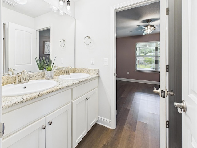 5740 Marigold Loop, Crestview, FL 32539 - bathroom with double vanity, wood finished floors, baseboards, and a ceiling fan