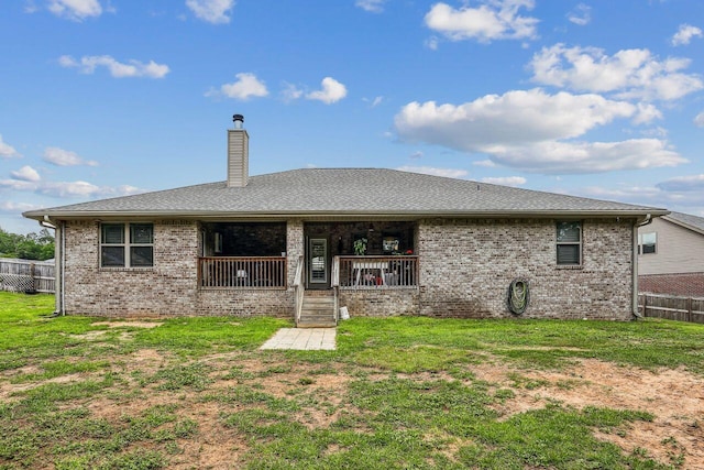 5744 Periwinkle Ln, Crestview, FL 32539 - rear view of house featuring a chimney, brick siding, and a porch