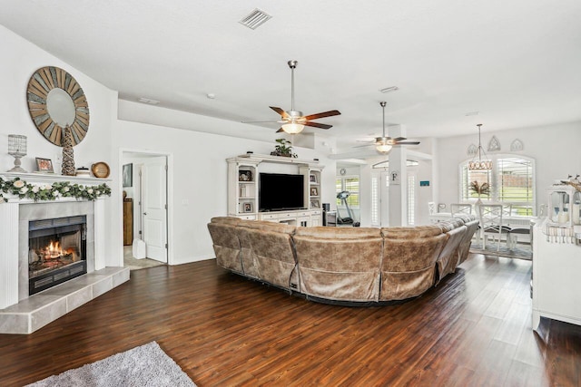 5744 Periwinkle Ln, Crestview, FL 32539 - living area featuring a ceiling fan, dark wood finished floors, a fireplace, and plenty of natural light