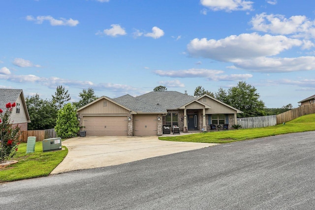 5744 Periwinkle Ln, Crestview, FL 32539 - view of front of property with an attached garage, driveway, a shingled roof, brick siding, and a porch