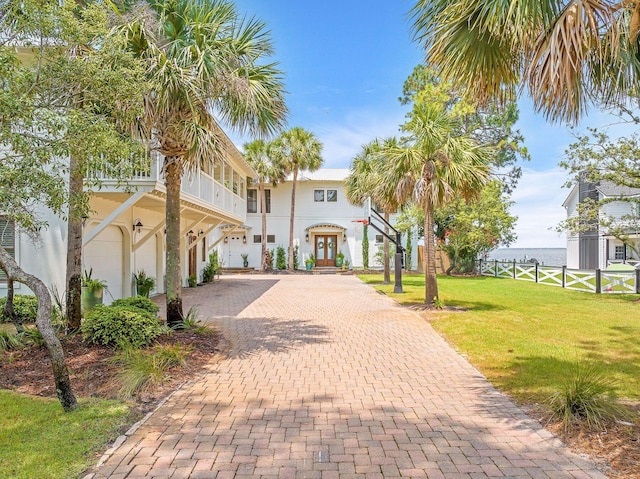 92 Carolyn Ln, Santa Rosa Beach, FL 32459 - view of front of house featuring decorative driveway, french doors, an attached garage, and stucco siding