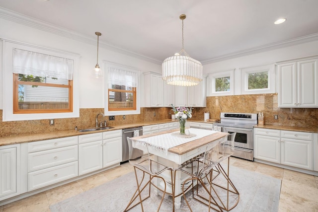 92 Carolyn Ln, Santa Rosa Beach, FL 32459 - kitchen with stainless steel appliances, a sink, white cabinets, crown molding, and backsplash