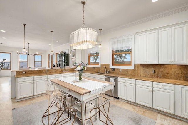 92 Carolyn Ln, Santa Rosa Beach, FL 32459 - kitchen with stainless steel dishwasher, a peninsula, a sink, white cabinetry, and crown molding