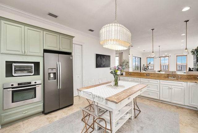92 Carolyn Ln, Santa Rosa Beach, FL 32459 - kitchen with stainless steel appliances, green cabinets, a sink, a chandelier, and crown molding
