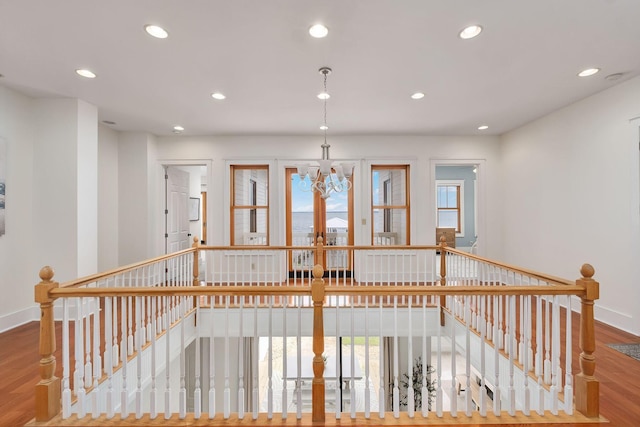 92 Carolyn Ln, Santa Rosa Beach, FL 32459 - hall with an upstairs landing, recessed lighting, wood finished floors, a chandelier, and baseboards
