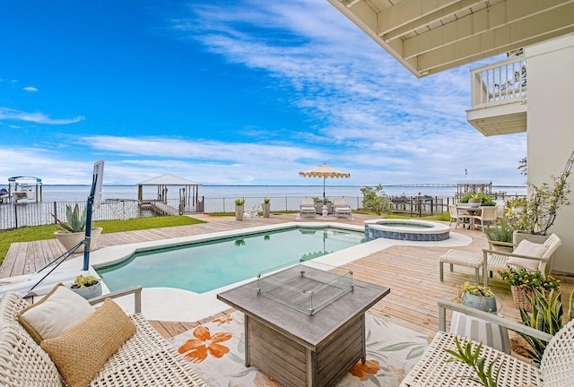 92 Carolyn Ln, Santa Rosa Beach, FL 32459 - view of pool with a water view, a pool with connected hot tub, an outdoor living space with a fire pit, and outdoor dining area