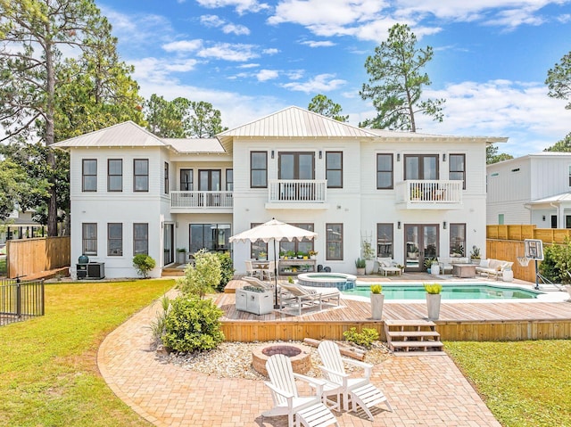 92 Carolyn Ln, Santa Rosa Beach, FL 32459 - rear view of house featuring a balcony, a patio, an outdoor living space, and a pool with connected hot tub