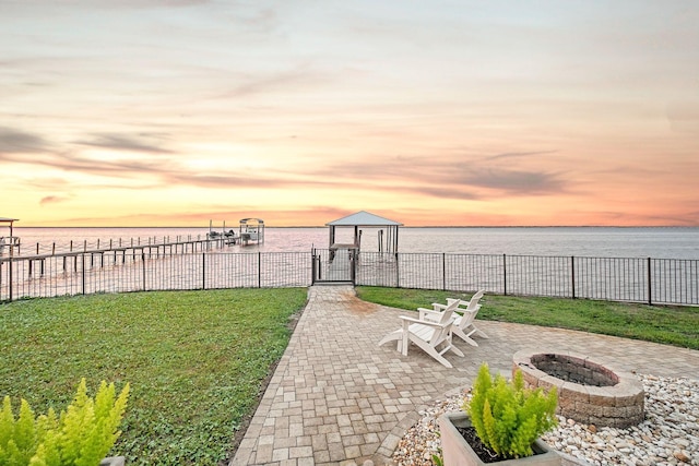 92 Carolyn Ln, Santa Rosa Beach, FL 32459 - patio terrace at dusk with an outdoor fire pit and a water view