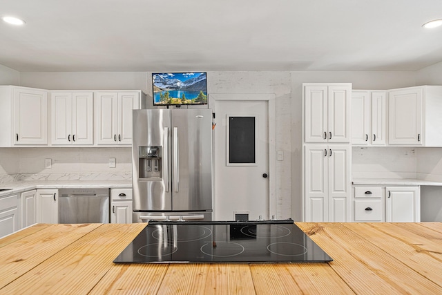 29 SE Alexandra Pl, Fort Walton Beach, FL 32548 - kitchen featuring stainless steel fridge, black electric stovetop, wood counters, white cabinets, and recessed lighting