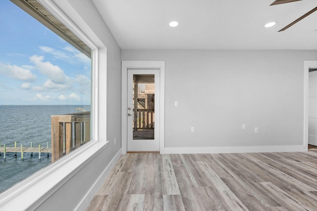 14351 State Highway 20, Niceville, FL 32578 - unfurnished room with a water view, wood finished floors, a ceiling fan, and recessed lighting