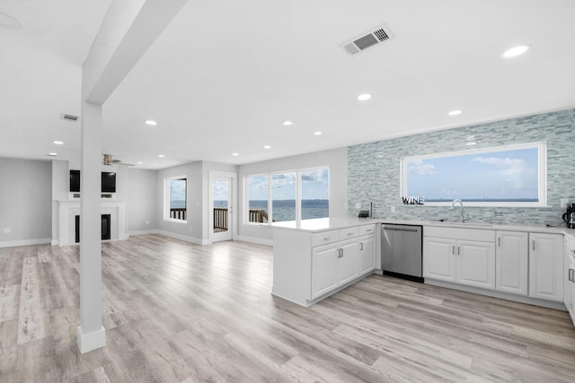 14351 State Highway 20, Niceville, FL 32578 - kitchen with stainless steel dishwasher, white cabinets, recessed lighting, light countertops, and a peninsula