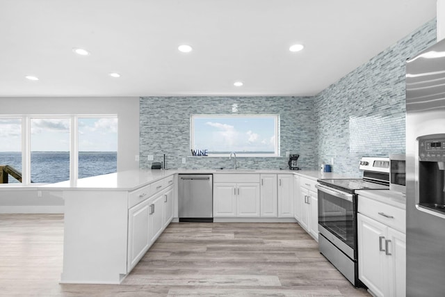 14351 State Highway 20, Niceville, FL 32578 - kitchen featuring stainless steel appliances, a peninsula, plenty of natural light, light countertops, and recessed lighting