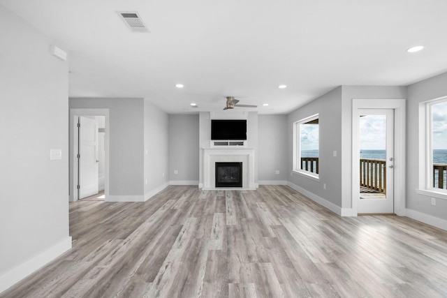 14351 State Highway 20, Niceville, FL 32578 - unfurnished living room featuring ceiling fan, recessed lighting, light wood-style flooring, and a fireplace with flush hearth