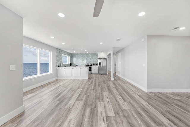 14351 State Highway 20, Niceville, FL 32578 - unfurnished living room featuring recessed lighting, light wood finished floors, and a ceiling fan
