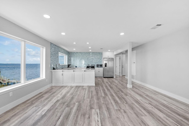 14351 State Highway 20, Niceville, FL 32578 - kitchen featuring stainless steel appliances, light countertops, recessed lighting, a water view, and white cabinetry