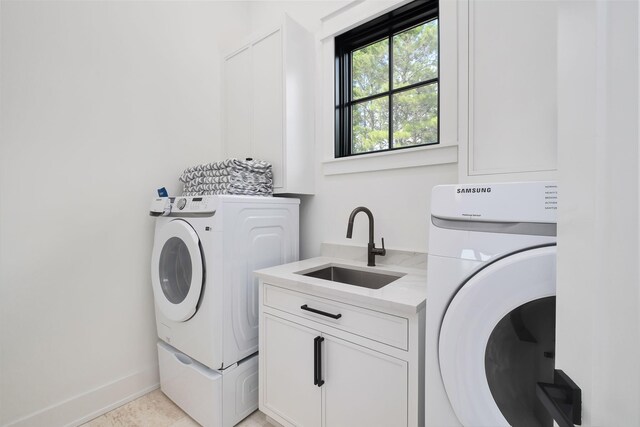 7570 E County Highway 30a, Watersound, FL 32461 - washroom featuring cabinet space, washer and clothes dryer, and baseboards