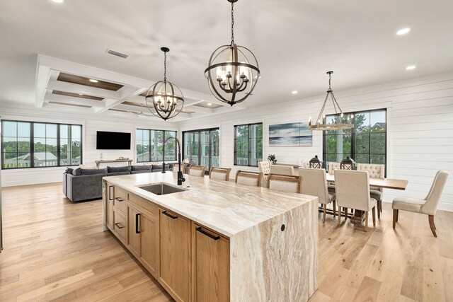 7570 E County Highway 30a, Watersound, FL 32461 - kitchen featuring a sink, a chandelier, light wood-style flooring, recessed lighting, and light stone countertops
