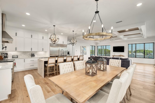 7570 E County Highway 30a, Watersound, FL 32461 - dining space with a chandelier, coffered ceiling, recessed lighting, light wood-type flooring, and beamed ceiling