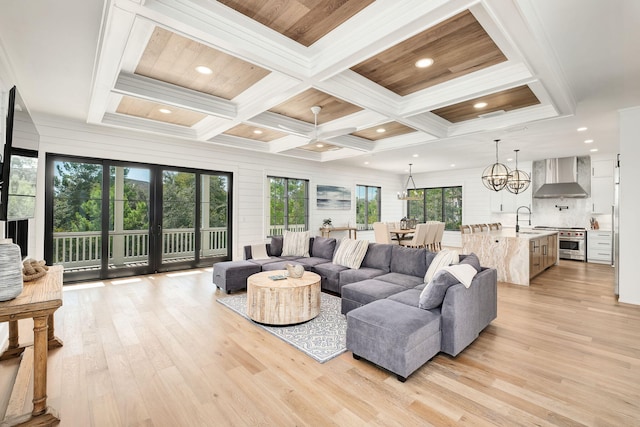 7570 E County Highway 30a, Watersound, FL 32461 - living room with light wood finished floors, coffered ceiling, a chandelier, beamed ceiling, and recessed lighting