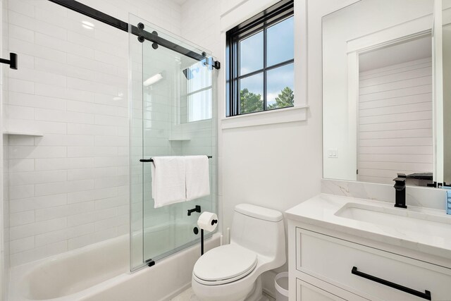 7570 E County Highway 30a, Watersound, FL 32461 - full bathroom with vanity, toilet, and bath / shower combo with glass door