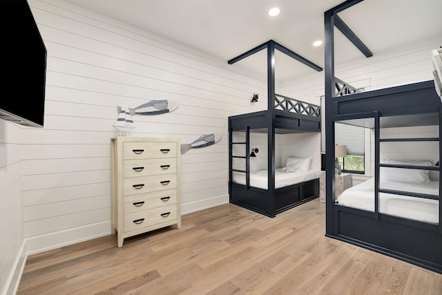 7570 E County Highway 30a, Watersound, FL 32461 - unfurnished bedroom with light wood-style floors, baseboards, recessed lighting, and wood walls