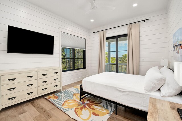 7570 E County Highway 30a, Watersound, FL 32461 - bedroom featuring light wood-type flooring, wooden walls, recessed lighting, and ceiling fan