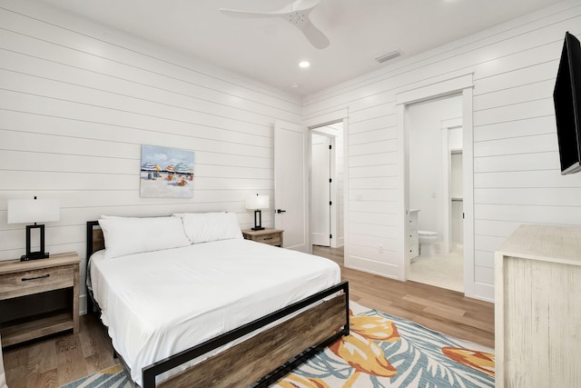 7570 E County Highway 30a, Watersound, FL 32461 - bedroom with wood finished floors, wood walls, recessed lighting, connected bathroom, and ceiling fan