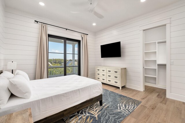 7570 E County Highway 30a, Watersound, FL 32461 - bedroom with wooden walls, light wood finished floors, recessed lighting, and a ceiling fan