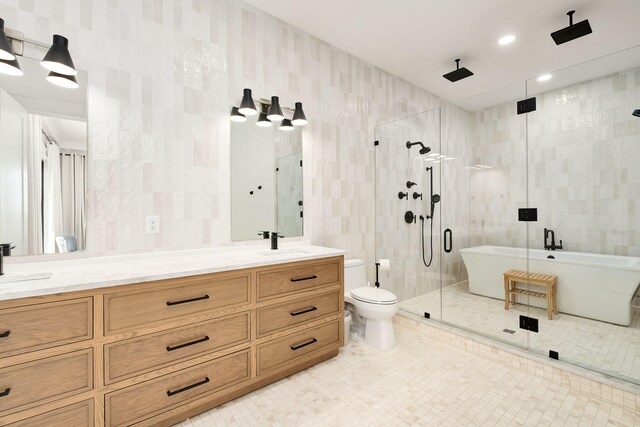 7570 E County Highway 30a, Watersound, FL 32461 - full bath featuring a shower stall, double vanity, a freestanding bath, tile walls, and tile patterned floors