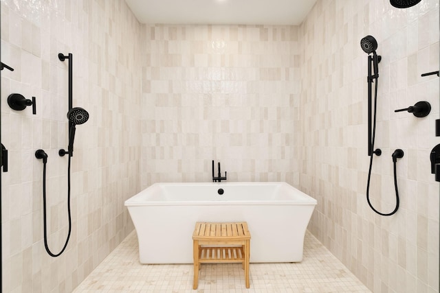 7570 E County Highway 30a, Watersound, FL 32461 - bathroom featuring tile walls, a freestanding tub, and a tile shower