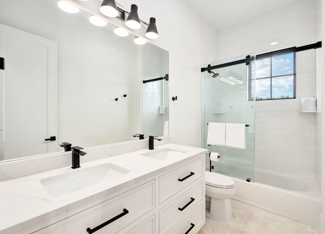 7570 E County Highway 30a, Watersound, FL 32461 - bathroom featuring toilet, double vanity, and enclosed tub / shower combo