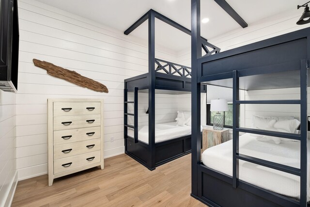7570 E County Highway 30a, Watersound, FL 32461 - bedroom with light wood-type flooring and wood walls