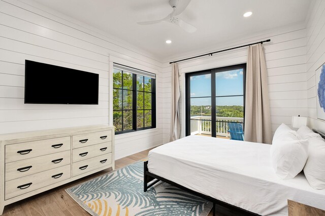 7570 E County Highway 30a, Watersound, FL 32461 - bedroom with access to exterior, wood finished floors, wooden walls, a ceiling fan, and recessed lighting
