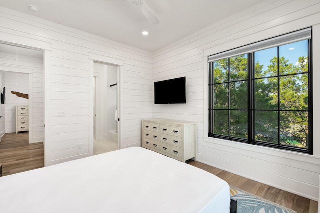 7570 E County Highway 30a, Watersound, FL 32461 - bedroom featuring wood walls, wood finished floors, recessed lighting, a ceiling fan, and baseboards