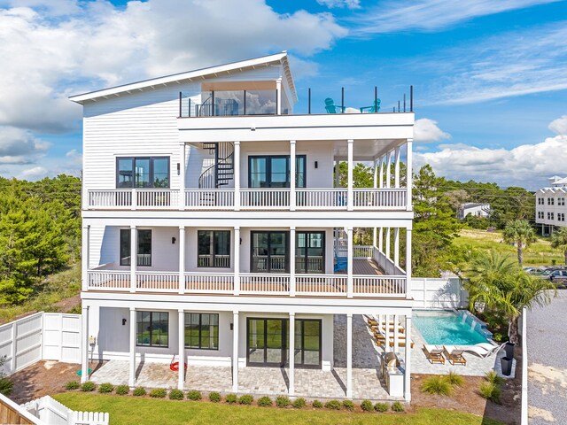 7570 E County Highway 30a, Watersound, FL 32461 - rear view of property with a balcony, a patio area, a fenced backyard, and an outdoor pool